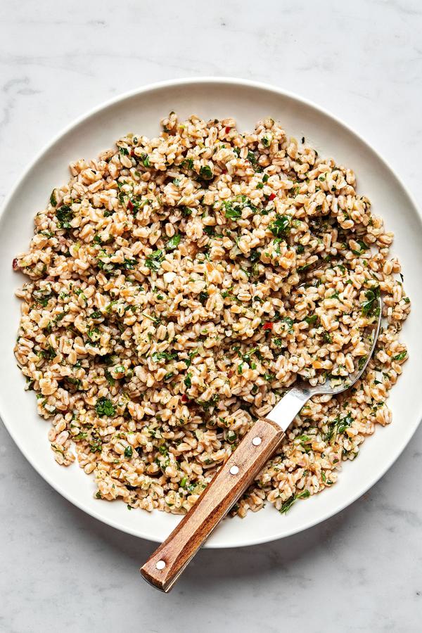 homemade farro in a serving bowl with a spoon