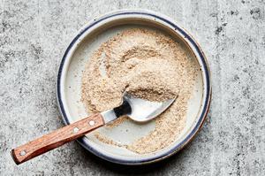 garlic powder, onion powder, chili powder and salt mixed in a bowl with a spoon to season potatoes for Irish nachos