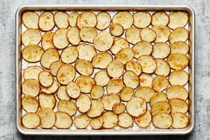 roasted potatoes on a baking sheet seasoned with garlic, onion and chili powders and salt