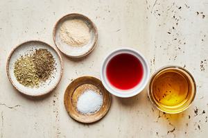 garlic powder, oregano, dried basil, salt, olive oil, and red wine vinegar in bowls to make homemade italian dressing