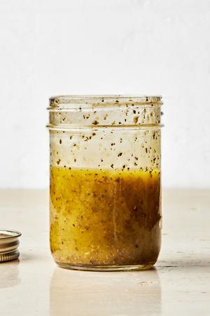 homemade Italian dressing in a mason jar made with garlic powder, oregano, dried basil, salt, olive oil, and red wine vinegar