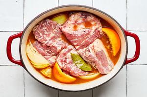 lamb shoulder, chicken stock, onion, orange and lime juice, spices and bay leaves in a slow cooker to make lamb tacos