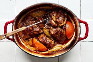 cooked lamb with chicken stock, onion, orange and lime juice, spices and bay leaves in a slow cooker to make lamb tacos