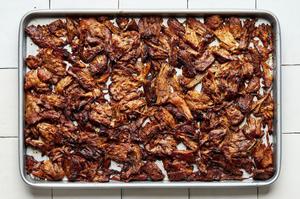 homemade shredded lamb, carnitas-style, on a baking sheet after being crisped in the oven