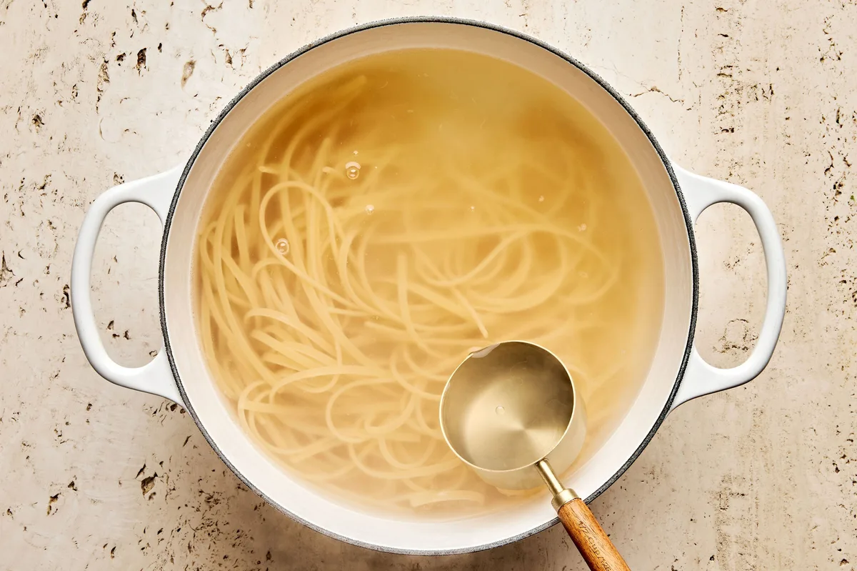 linguine pasta noodles cooking in a pot of salted boiling water