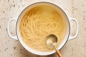 linguine pasta noodles cooking in a pot of salted boiling water