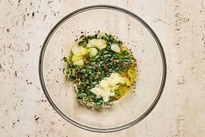 Lemon garlic sauce in a bowl made with olive oil, butter, parsley, lemon juice & zest, garlic, red pepper flakes & salt