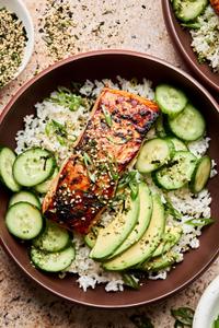A vibrant miso salmon rice bowl with tender salmon and steamed rice topped with avocado, cucumber and furikake