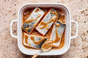 salmon marinating in ground ginger, miso paste, sesame oil, soy sauce, vinegar, brown sugar, and grated ginger