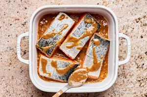 salmon marinating in ground ginger, miso paste, sesame oil, soy sauce, vinegar, brown sugar, and grated ginger