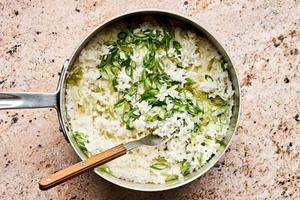 a pot of cooked rice with grated ginger, green onions, garlic, and avocado oil
