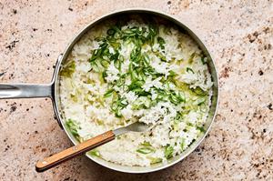 a pot of cooked rice with grated ginger, green onions, garlic, and avocado oil