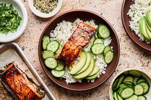 A vibrant miso salmon rice bowl with tender salmon and steamed rice topped with avocado, cucumber and furikake