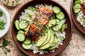 A vibrant miso salmon rice bowl with tender salmon and steamed rice topped with avocado, cucumber and furikake