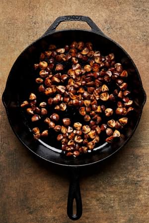 mushrooms being cooked in salt in a frying pan to make mushroom gravy