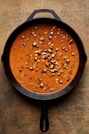 mushroom gravy being cooked in a pan made with spices, olive oil, butter, flour, stock, thyme, soy sauce & lemon juice