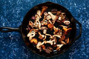 onions, garlic and mushrooms being cooked in olive oil in a skillet