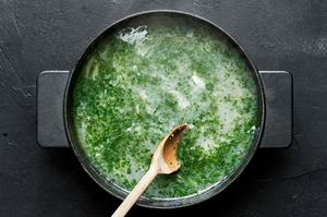 wine sauce for mussels being stirred in a pot made with butter, shallot, garlic, white wine, parsley and lemon juice