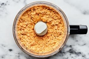 Homemade nutty carrot dip in a food processor on the counter. Made with  Carrots, Pecans, Cream cheese, Mayo and seasonings