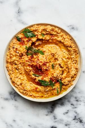 A bowl of homemade nutty carrot dip on the counter made with Carrots, Pecans, Cream cheese, Mayo, and seasonings