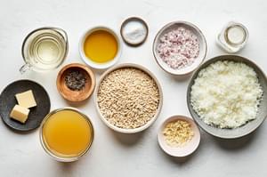 orzo, olive oil, chicken broth, shallot, garlic, white wine, salt, butter, cream, manchego cheese and pepper in bowls