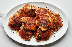 oven baked chicken thighs on a serving platter seasoned with olive oil, salt, garlic powder, onion powder, paprika, & pepper