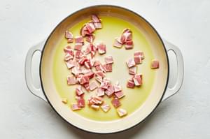 diced guanciale being cooked in olive oil in a skillet for homemade pasta carbonara