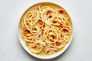 Creamy pasta carbonara topped with crispy pancetta and freshly grated Parmesan, garnished with black pepper and flaky salt