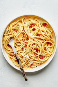 Creamy pasta carbonara topped with crispy pancetta and freshly grated Parmesan, garnished with black pepper and flaky salt