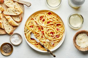 Creamy pasta carbonara topped Parmesan, pepper and flaky salt served with bread