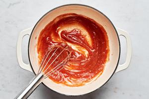 peach juices, vanilla, lemon juice, nutmeg, cinnamon, salt and cornstarch being whisked into a slurry in a pot for peach pie
