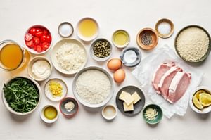 ingredients in bowls for pork milanese bowls with fried chicken, lemon parmesan rice and creamy lemon dressing