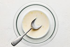 creamy lemon dressing in a bowl made with lemon zest & juice, sugar, garlic, minced, salt, vinegar, mayonnaise & olive oil