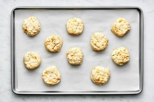 unbaked homemade red lobster cheddar bay biscuits on a baking sheet lined with parchment paper
