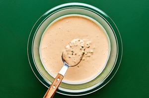 a bowl of Russian style dressing made with mayo, ketchup, relish, sriracha, lemon juice, onion, garlic, salt & pepper