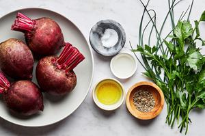 4 whole beets, salt, olive oil, pepper, white vinegar and fresh herbs on the counter to use to make homemade roasted beets