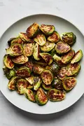 roasted brussels sprouts in a serving bowl seasoned with olive oil and salt