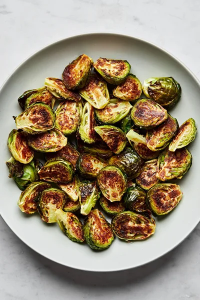 roasted brussels sprouts in a serving bowl seasoned with olive oil and salt