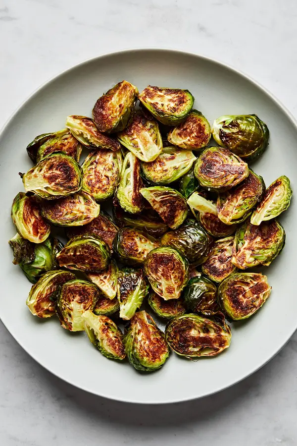 roasted brussels sprouts in a serving bowl seasoned with olive oil and salt