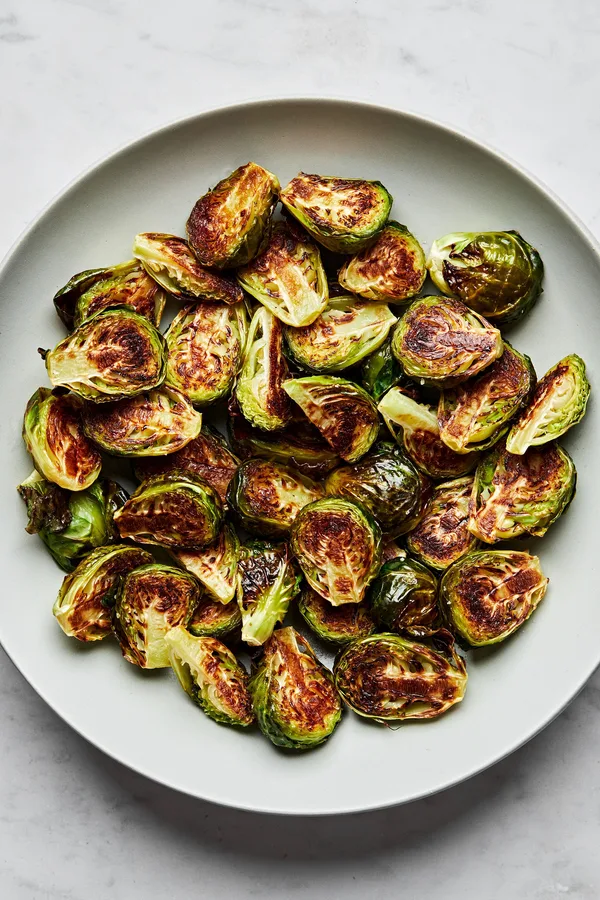 roasted brussels sprouts in a serving bowl seasoned with olive oil and salt