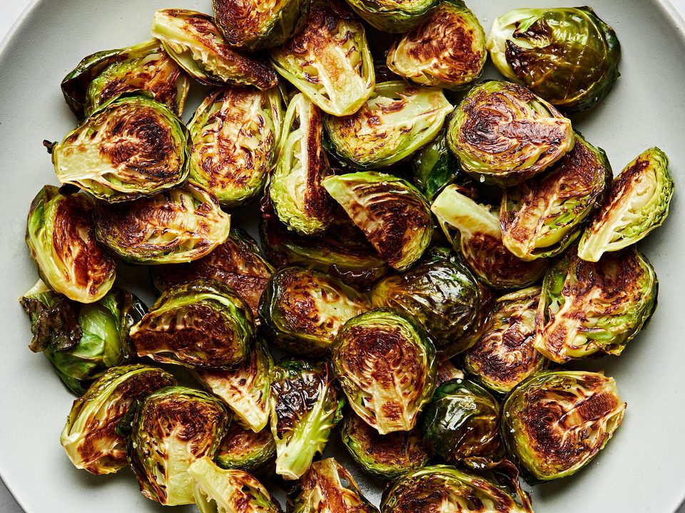 roasted brussels sprouts in a serving bowl seasoned with olive oil and salt