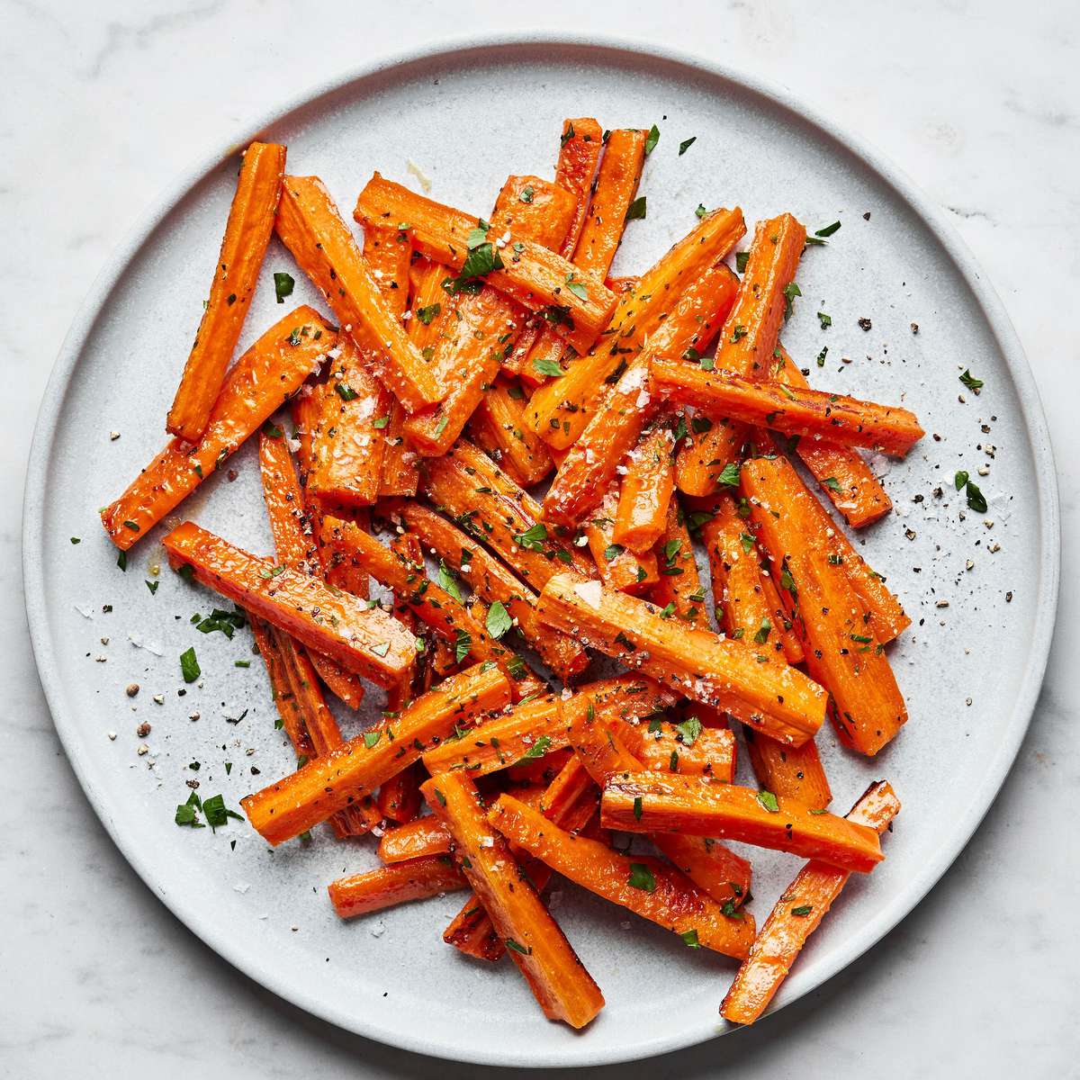 a plate of perfectly roasted carrots with caramelized edges, the perfect fall and winter side side
