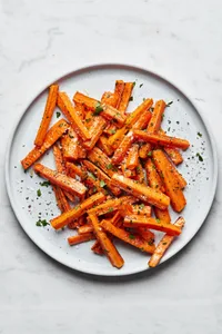 a plate of perfectly roasted carrots with caramelized edges, the perfect fall and winter side side