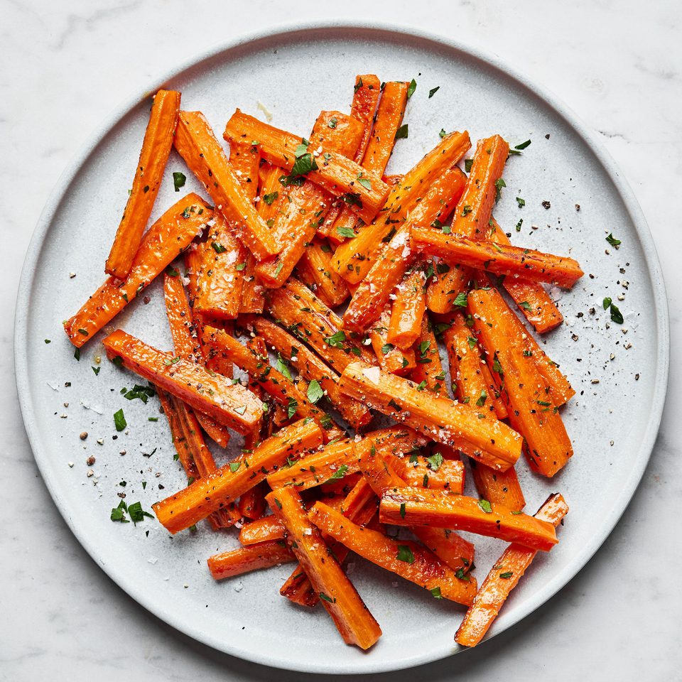 a plate of perfectly roasted carrots with caramelized edges, the perfect fall and winter side side