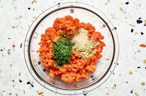 ground salmon, onion powder, garlic powder, Old Bay seasoning, mustard powder, lemon juice and minced chives in a glass bowl