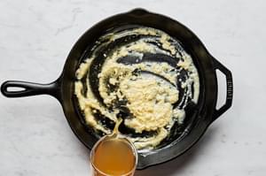 butter and garlic being cooked in a pan for scalloped potatoes