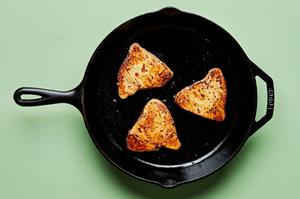 marinated ahi tuna being seared in a skillet for homemade seared ahi tuna with cucumber salad