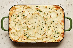 Shepherd’s pie in a casserole, topped with golden mashed potatoes and baked until lightly browned, topped with pepper & thyme