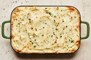 Shepherd’s pie in a casserole, topped with golden mashed potatoes and baked until lightly browned, topped with pepper & thyme