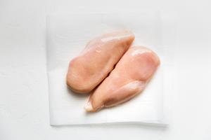 2 raw chicken breasts ready to be cooked to make shredded chicken